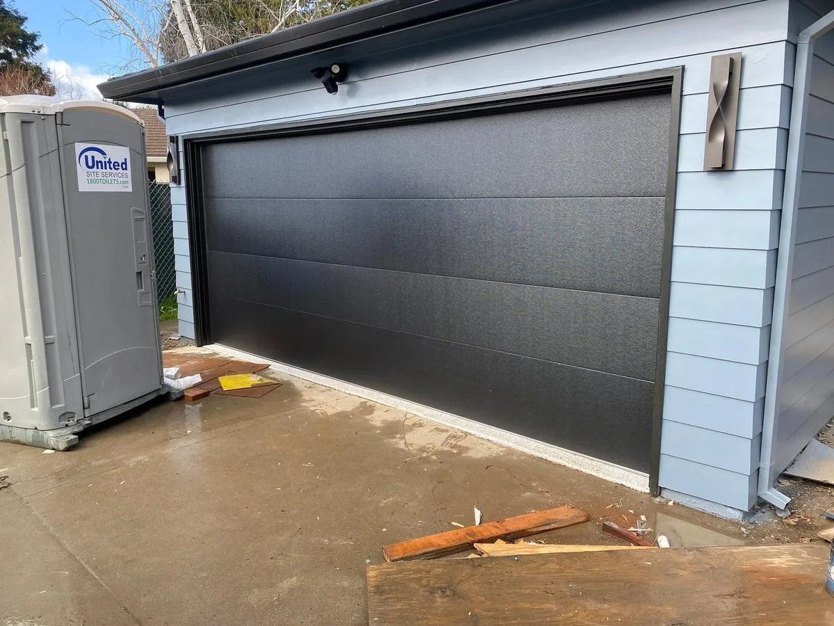 Charcoal flush modern garage door on new construction