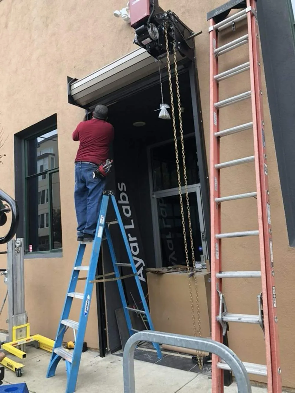Technician installing commercial garage door opener