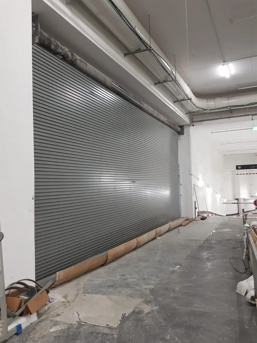 Large commercial rolling steel shutter door inside warehouse