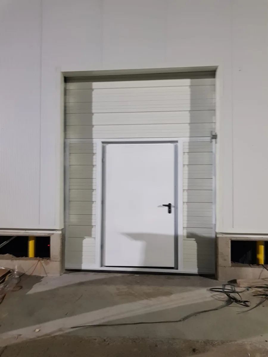 Commercial roll-up door with pedestrian pass-through door