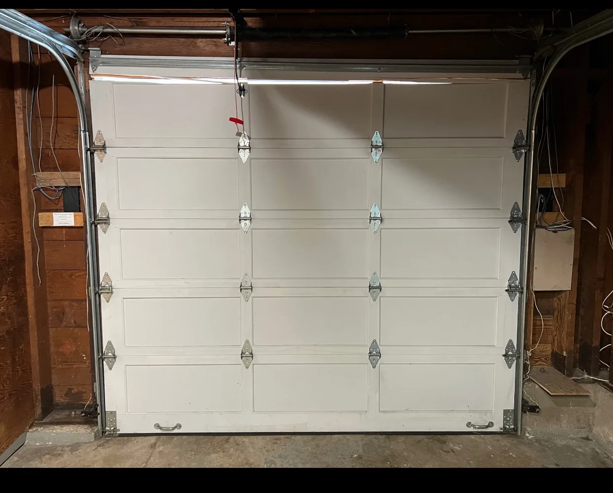 Interior view of garage door hinges, rollers, and brackets