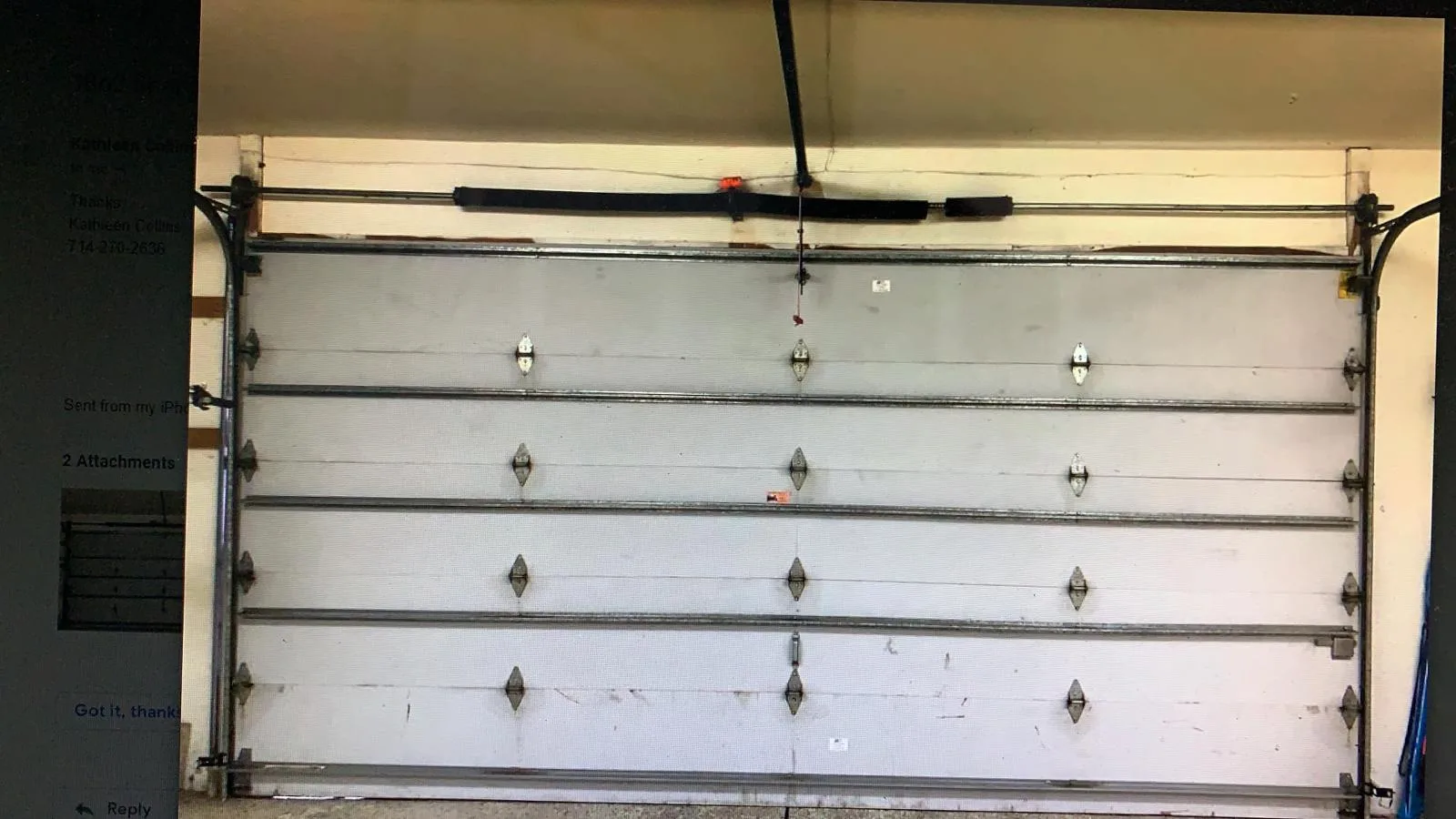 Interior view of garage door showing broken torsion spring