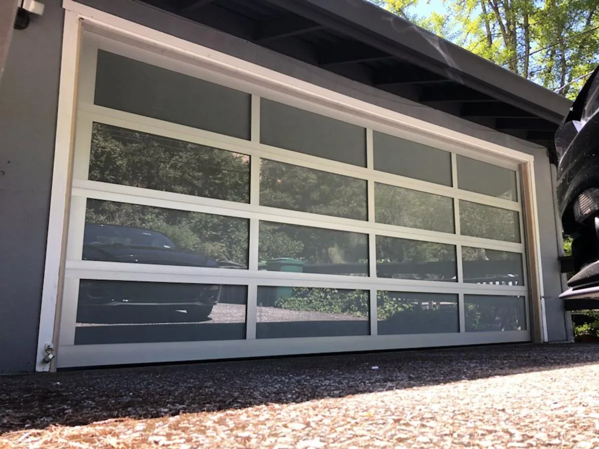Glass panel garage door with white aluminum frame