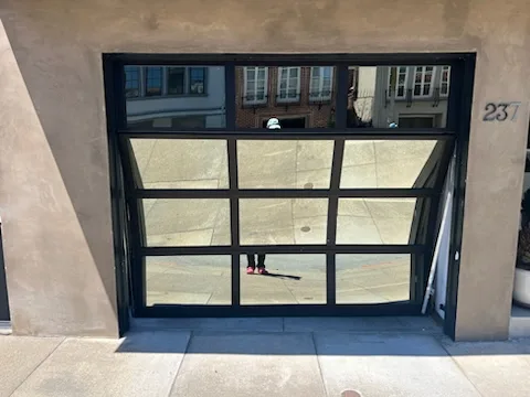 Modern full-view aluminum and glass garage door with black frame