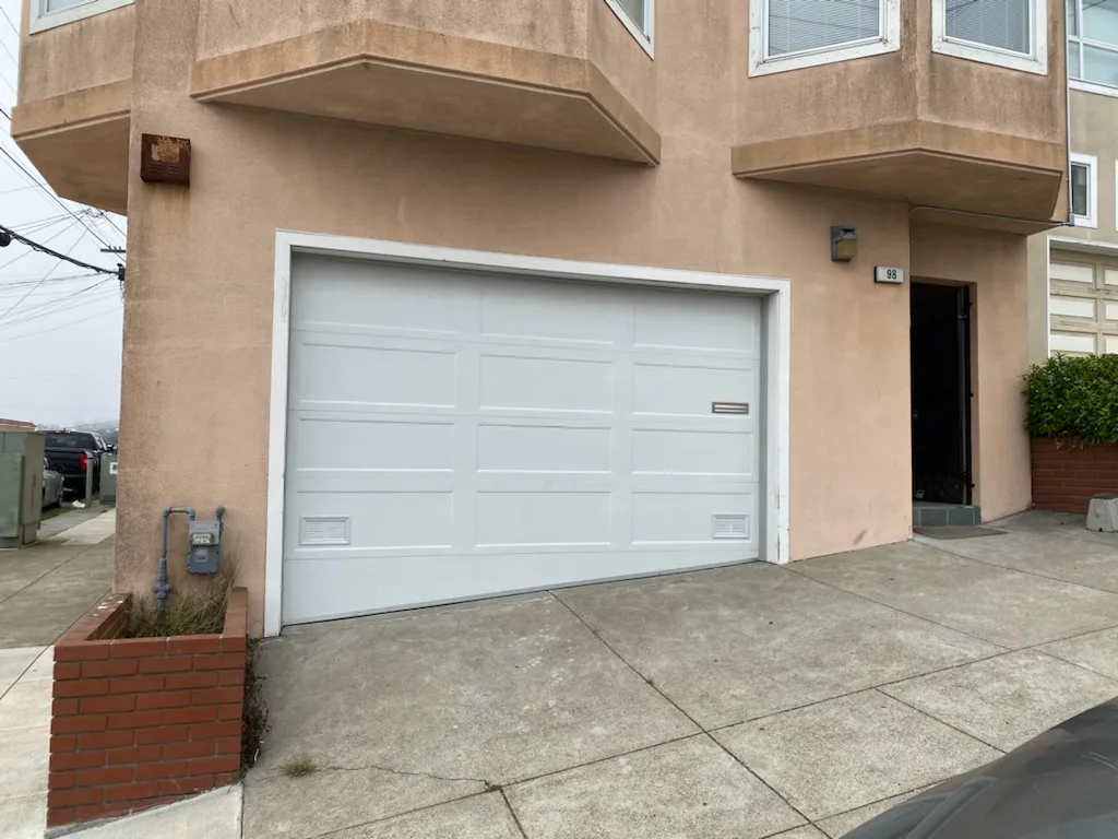 New white flush panel garage door after replacement