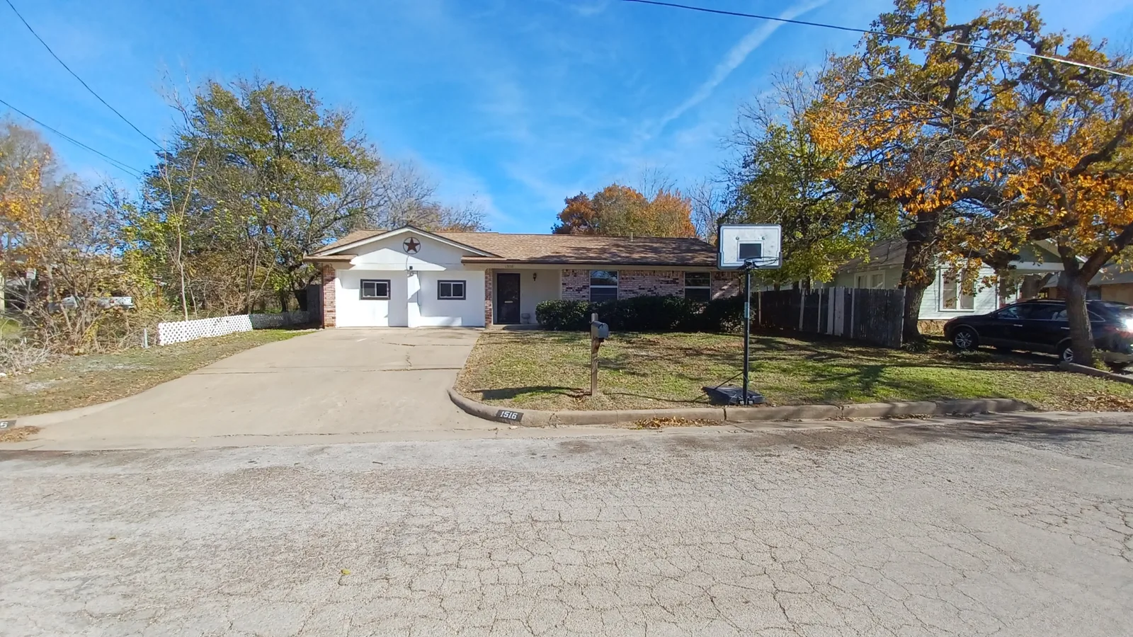White two-car garage door on house with basketball hoop