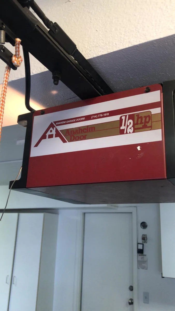Old Anaheim Door half HP garage door opener on ceiling