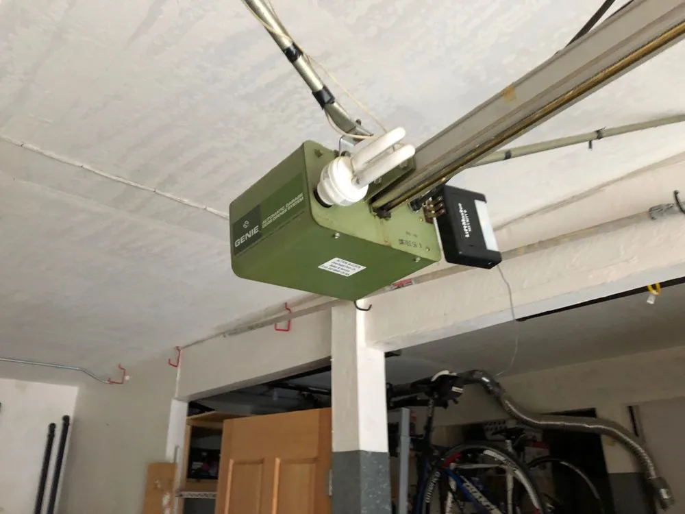 Old Genie garage door opener mounted on ceiling