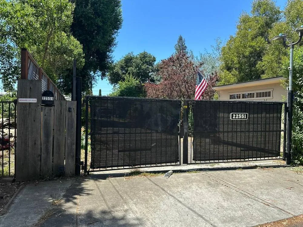 Privacy driveway gate with screening on residential property