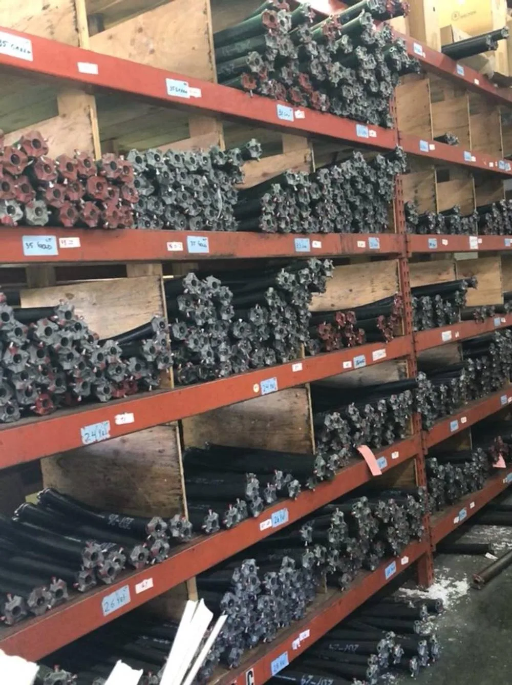 Warehouse shelves stocked with garage door torsion springs