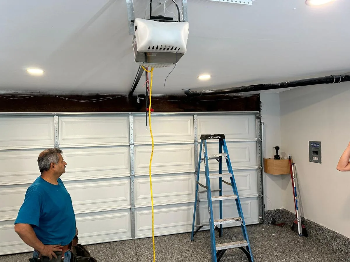 Integrity Garage Doors technician installing a garage door opener