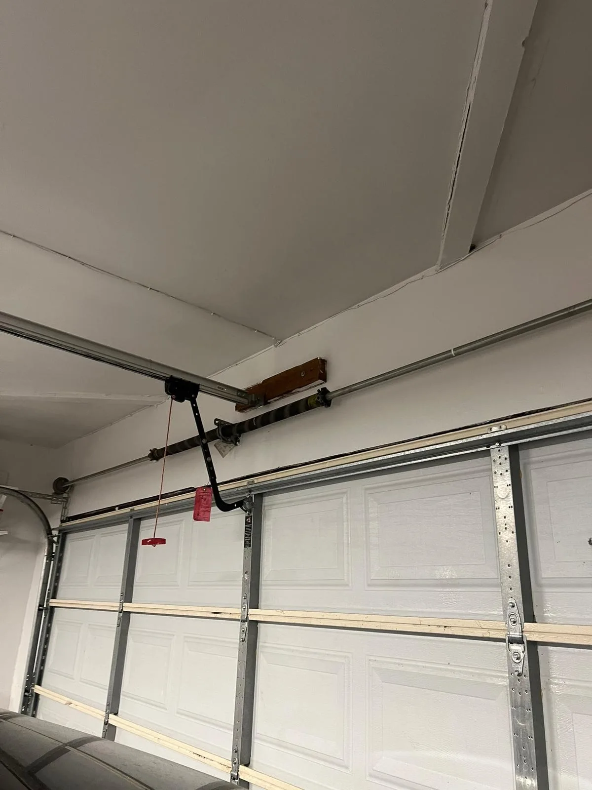Torsion spring system above residential garage door - do not touch