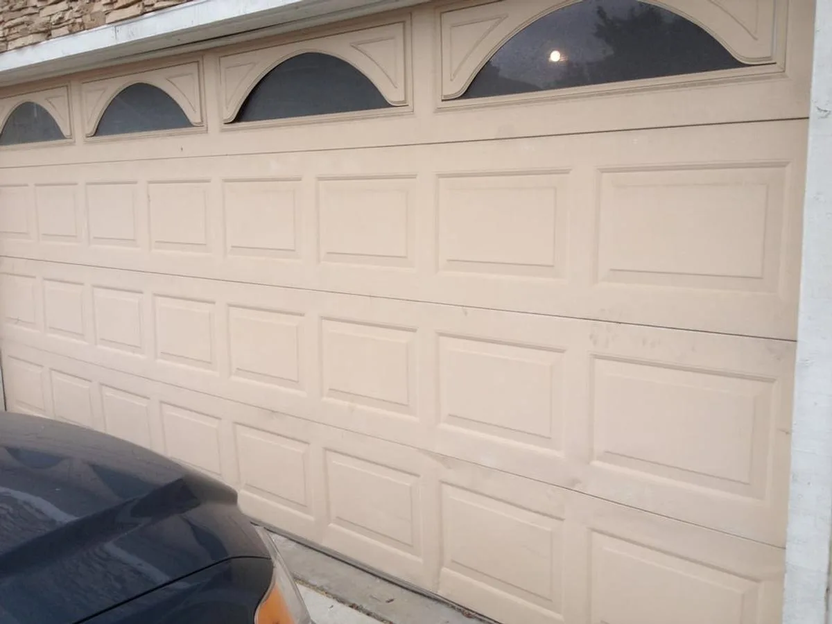 Traditional raised panel garage door with arched decorative windows