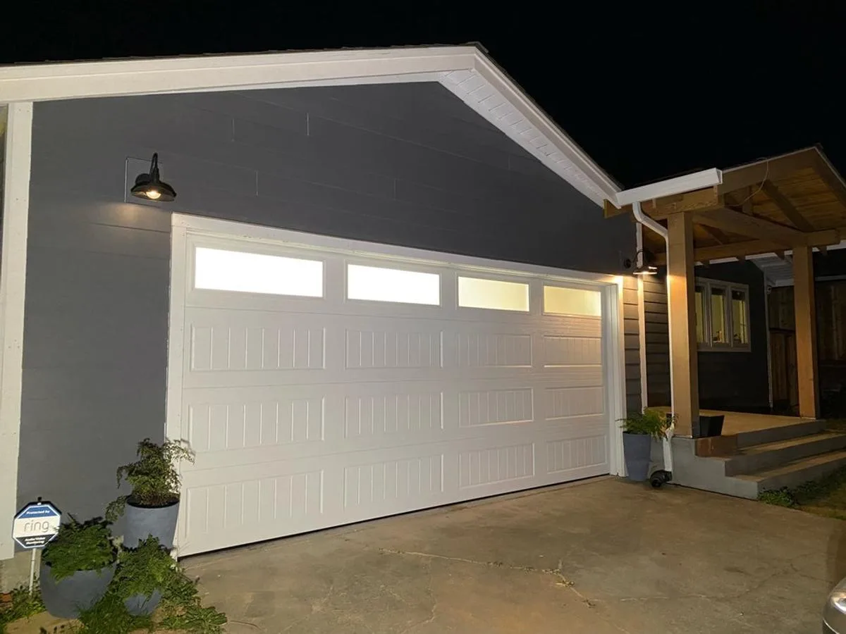 Long panel two-car garage door with window inserts