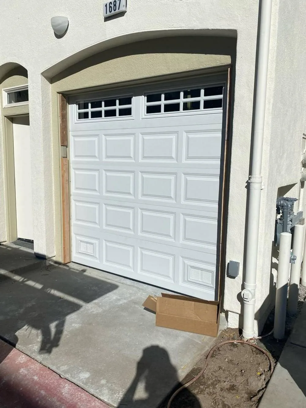White raised panel single car garage door with grid windows