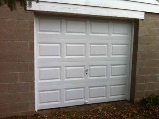 Clean white single-car raised-panel garage door