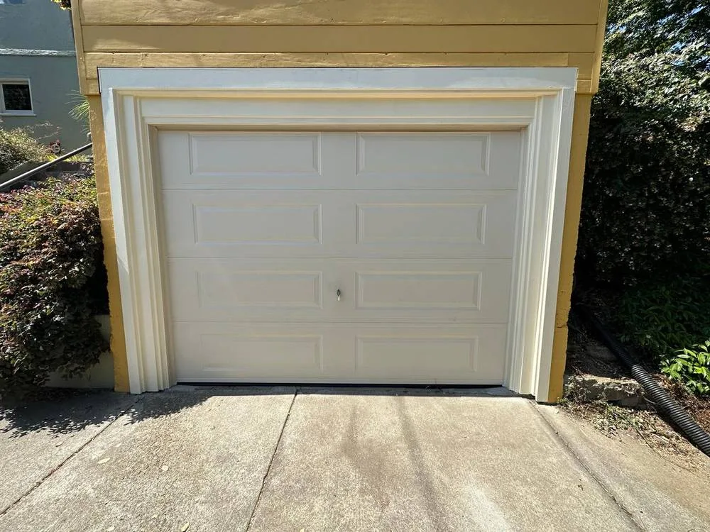 White raised panel single car garage door installation