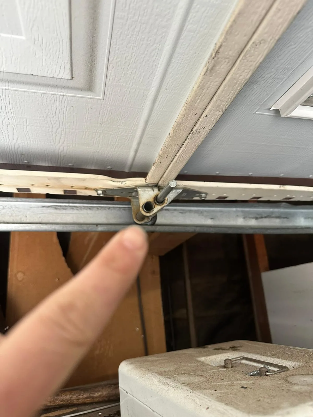 Worn garage door hinge found during emergency inspection
